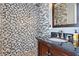 Bathroom with gray hexagon tile and a wood vanity with a stone countertop at 15 Corinne St # B, Charleston, SC 29403