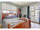 Inviting bedroom boasts a wooden bed frame, private balcony, and bright, airy atmosphere at 15 Corinne St # B, Charleston, SC 29403