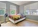 Sunny bedroom featuring two windows, a ceiling fan, and hardwood floors at 15 Corinne St # B, Charleston, SC 29403
