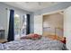 Bedroom features a gray comforter, hardwood floors, and door leading to a balcony at 15 Corinne St # B, Charleston, SC 29403