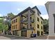 View of the home featuring a three-story facade with balconies, private garage and modern architectural design at 15 Corinne St # B, Charleston, SC 29403
