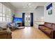 A modern living room is spacious and bright with hardwood floors and tall ceilings, and bathed in natural light at 15 Corinne St # B, Charleston, SC 29403