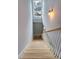Bright stairway with white railings, hardwood steps, and a window bringing in natural light at 15 Corinne St # B, Charleston, SC 29403