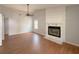 Bright living room featuring hardwood floors, a ceiling fan, and a cozy stone fireplace at 154 Tabby Creek Cir, Summerville, SC 29486