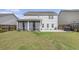 Home's backyard features a screened in porch and lush green lawn at 1540 Dawn Mist Way, Charleston, SC 29414