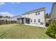 A well-maintained backyard with a screened-in porch and green lawn at 1540 Dawn Mist Way, Charleston, SC 29414