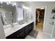 Bathroom featuring dual sinks, a shower, and a doorway to the walk-in closet at 1540 Dawn Mist Way, Charleston, SC 29414