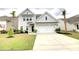 Charming two-story home with a well-manicured lawn and attached two-car garage at 1540 Dawn Mist Way, Charleston, SC 29414