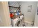 Laundry room featuring a washer, dryer, folding counter, shelving and patterned wallpaper at 1540 Dawn Mist Way, Charleston, SC 29414
