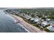 Aerial view of beachfront properties, showing the coastline, houses, and a scenic beach at 1702 Palmetto Blvd, Edisto Island, SC 29438