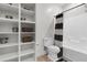 Bathroom featuring tub, toilet, floating shelves and decorative elements at 1702 Palmetto Blvd, Edisto Island, SC 29438