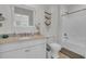 Bright bathroom featuring a single sink vanity with a shower and tub at 1702 Palmetto Blvd, Edisto Island, SC 29438
