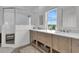 Bathroom with double sinks, wooden cabinets, walk-in shower, and natural light at 1702 Palmetto Blvd, Edisto Island, SC 29438