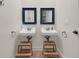 Bathroom featuring double sinks, step stools, and accent mirrors at 1702 Palmetto Blvd, Edisto Island, SC 29438
