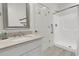 Bright bathroom featuring a single sink vanity with a walk-in shower at 1702 Palmetto Blvd, Edisto Island, SC 29438