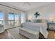 Bright bedroom featuring a ceiling fan, wooden floors, and a coastal themed wall accent at 1702 Palmetto Blvd, Edisto Island, SC 29438