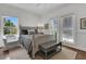 Cozy bedroom with two windows, a ceiling fan, and comfortable chair at 1702 Palmetto Blvd, Edisto Island, SC 29438
