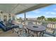 Spacious covered deck with comfortable seating and dining area overlooking the ocean at 1702 Palmetto Blvd, Edisto Island, SC 29438