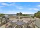 Outdoor deck with ocean view, grill, lounge chairs, and a small table, great for enjoying coastal living at 1702 Palmetto Blvd, Edisto Island, SC 29438