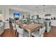 Open dining room features a wooden table, seating for eight, and views of the kitchen and living room at 1702 Palmetto Blvd, Edisto Island, SC 29438