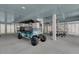 Spacious garage with golf cart and ping pong table at 1702 Palmetto Blvd, Edisto Island, SC 29438