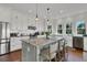 Bright modern kitchen features a center island, stainless steel appliances, and stylish pendant lighting at 1702 Palmetto Blvd, Edisto Island, SC 29438