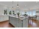 A beautiful open-concept kitchen featuring a large island with marble countertops and stainless steel hardware at 1702 Palmetto Blvd, Edisto Island, SC 29438