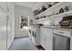 Well-lit laundry room with modern washer and dryer, ample storage, and countertops at 1702 Palmetto Blvd, Edisto Island, SC 29438