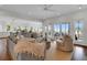 Open-concept living area with hardwood floors, comfortable seating, and scenic ocean views through large sliding glass doors at 1702 Palmetto Blvd, Edisto Island, SC 29438