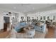 Bright, open-concept living room with modern decor and hardwood floors throughout the area at 1702 Palmetto Blvd, Edisto Island, SC 29438
