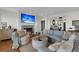 Cozy living room with a fireplace, comfortable seating, and plenty of natural light at 1702 Palmetto Blvd, Edisto Island, SC 29438