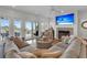 Bright living room with fireplace, plush seating, and sliders leading to a deck with ocean views, perfect for relaxing at 1702 Palmetto Blvd, Edisto Island, SC 29438