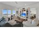Inviting living room with ocean view, comfortable seating, and built-in bookshelves at 1702 Palmetto Blvd, Edisto Island, SC 29438