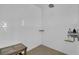A clean, bright, white tiled shower area with a small wooden bench at 1702 Palmetto Blvd, Edisto Island, SC 29438