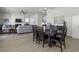 Open-concept dining room featuring a dark wood table, stylish chandelier, and seamless flow into the living area at 181 Ashworth Dr, Summerville, SC 29486