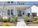 Inviting front porch with classic columns, a cozy seating area, and a beautifully decorated entryway to welcome guests at 181 Ashworth Dr, Summerville, SC 29486