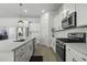 Well-equipped kitchen featuring white cabinets, stainless-steel appliances, quartz countertops, and ample storage space at 181 Ashworth Dr, Summerville, SC 29486