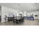 Open-concept dining area flowing into a kitchen with a large island, modern lighting, and stainless-steel appliances at 181 Ashworth Dr, Summerville, SC 29486