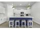 Stylish kitchen island featuring white countertops, blue accents, and seating, illuminated by pendant lighting fixtures at 181 Ashworth Dr, Summerville, SC 29486