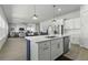 Bright, modern kitchen with white cabinets, stainless steel appliances, and an island with a contrasting blue base at 181 Ashworth Dr, Summerville, SC 29486