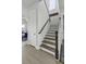 Elegant staircase with wooden treads and white risers, complemented by a light-filled hallway at 181 Ashworth Dr, Summerville, SC 29486