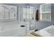 Bright bathroom featuring a soaking tub with shower and large windows at 1844 Hubbell Dr, Mount Pleasant, SC 29466