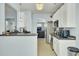 Well-lit kitchen with modern stainless steel appliances and adjacent living area for seamless entertaining at 1844 Hubbell Dr, Mount Pleasant, SC 29466