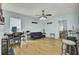 Bright living room features wood floors, modern ceiling fan, and flexible spaces for work and relaxation at 1844 Hubbell Dr, Mount Pleasant, SC 29466