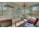 Screened porch with outdoor furniture and chandelier lighting at 1844 Hubbell Dr, Mount Pleasant, SC 29466