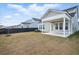 Home exterior view with covered patio, a green lawn, and dark wood fencing that provides ample privacy at 190 Steepbrook, Summerville, SC 29486