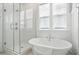 Modern bathroom with a luxurious soaking tub, glass-enclosed shower, and stylish fixtures at 190 Steepbrook, Summerville, SC 29486