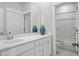 Bright bathroom features a white vanity with marble countertop, large mirror, and a shower with tub at 190 Steepbrook, Summerville, SC 29486