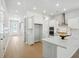 Bright, modern kitchen with white cabinets, stainless steel appliances, and a center island, great for meal prep at 190 Steepbrook, Summerville, SC 29486