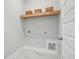 Bright laundry room with a wooden shelf and baskets, plus sleek marble-style flooring at 190 Steepbrook, Summerville, SC 29486